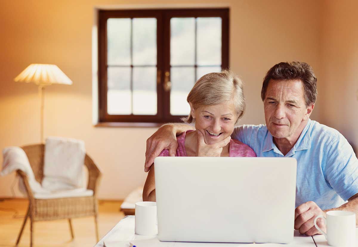 Senior couple retirement planning on laptop- RETIREMENT INCOME STRATEGIES